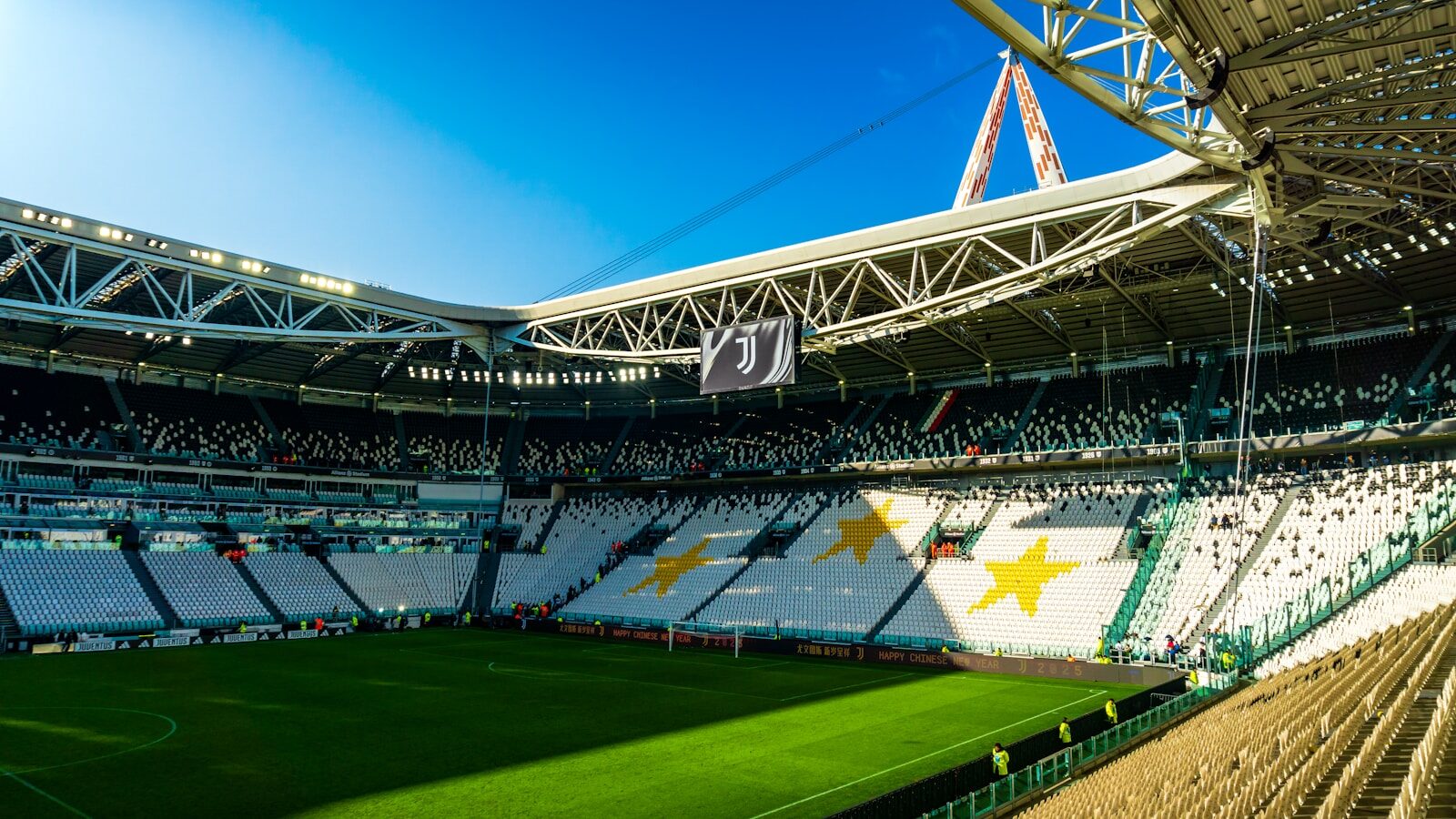 Modern soccer stadium with green field and white seats