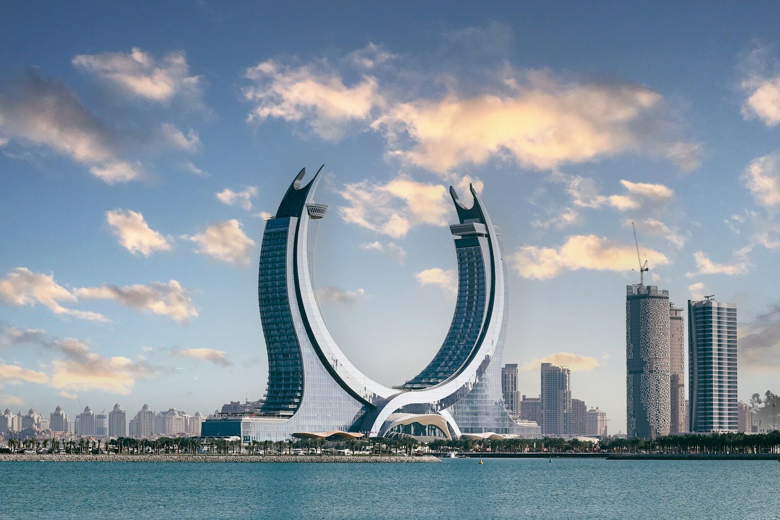 The crescent-shaped Katara Towers rising above the waterfront in Lusail, Qatar
